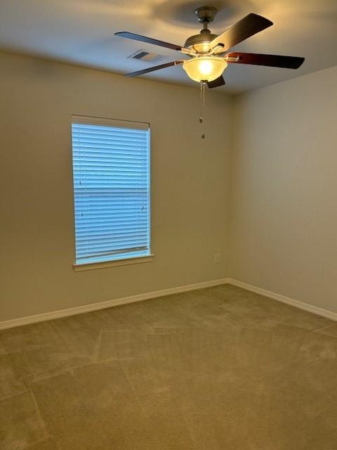 spare room with carpet flooring and ceiling fan