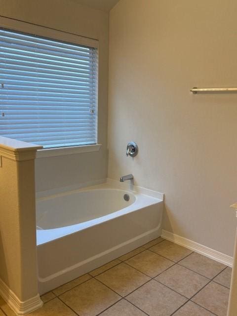 bathroom with a bathing tub and tile patterned flooring