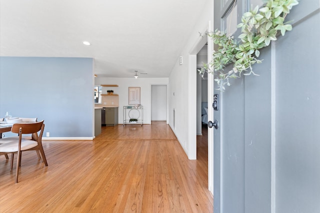 foyer with baseboards and light wood-type flooring