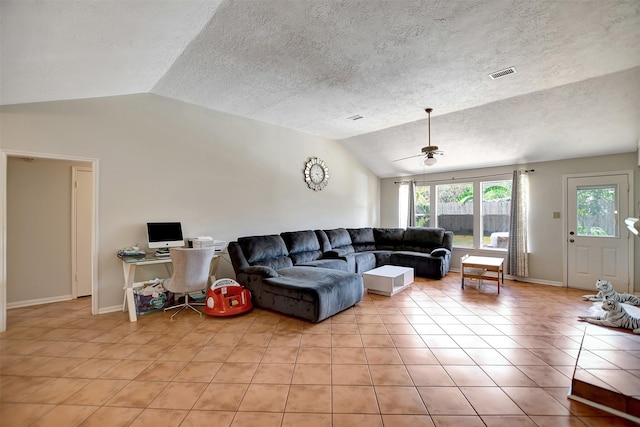 living area featuring baseboards, visible vents, a ceiling fan, lofted ceiling, and light tile patterned flooring