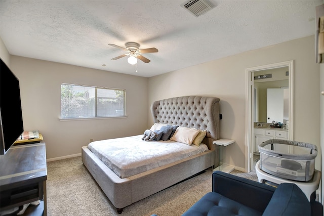 bedroom featuring baseboards, visible vents, a ceiling fan, light colored carpet, and a textured ceiling