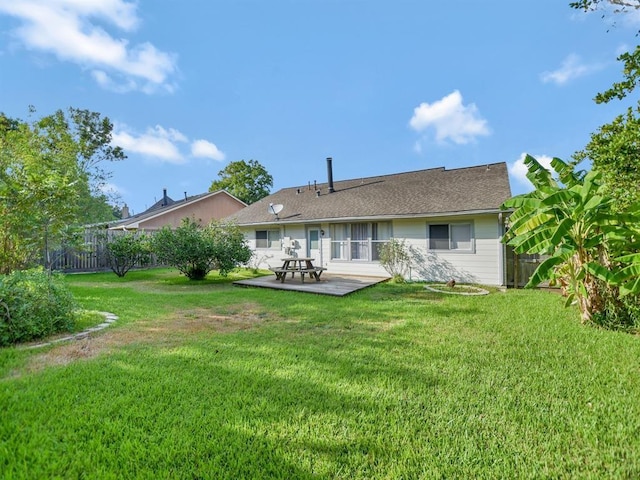 rear view of house featuring a yard and a patio area