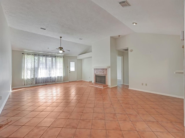 unfurnished living room with a high end fireplace, visible vents, vaulted ceiling, and light tile patterned flooring