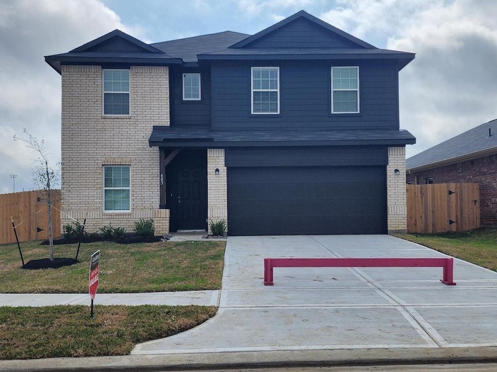 front of property with a garage and a front yard