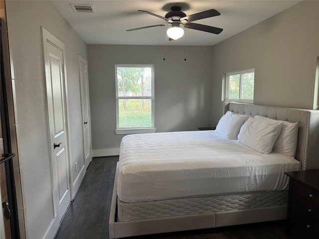 bedroom with ceiling fan and dark hardwood / wood-style floors