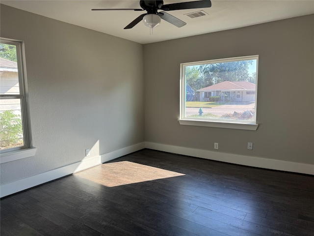 unfurnished room featuring dark wood-type flooring and ceiling fan