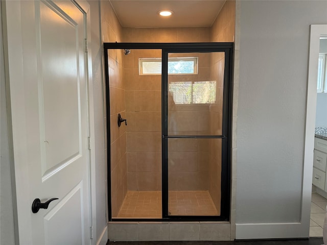 bathroom featuring walk in shower and vanity