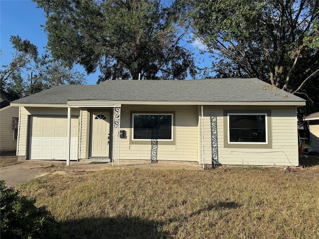 ranch-style home with a garage, concrete driveway, a front lawn, and a shingled roof