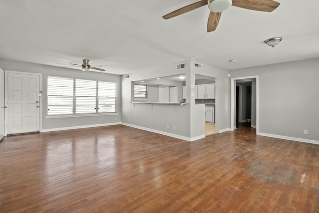 unfurnished living room featuring hardwood / wood-style floors and ceiling fan