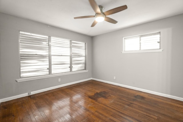 spare room with ceiling fan and dark hardwood / wood-style floors