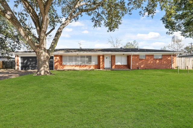 ranch-style home featuring a garage and a front yard