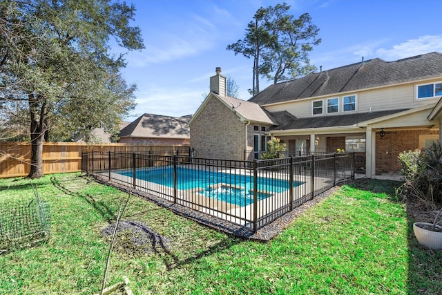 view of pool with a yard