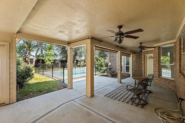 view of patio / terrace with a fenced in pool and ceiling fan