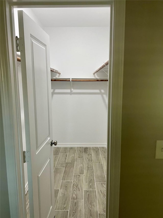 spacious closet featuring wood tiled floor