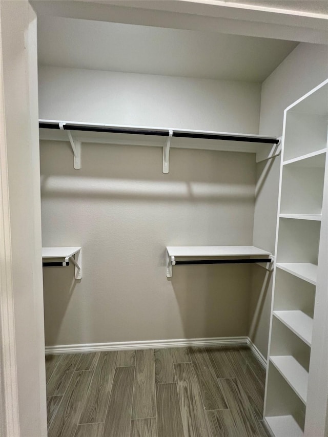 walk in closet featuring wood tiled floor