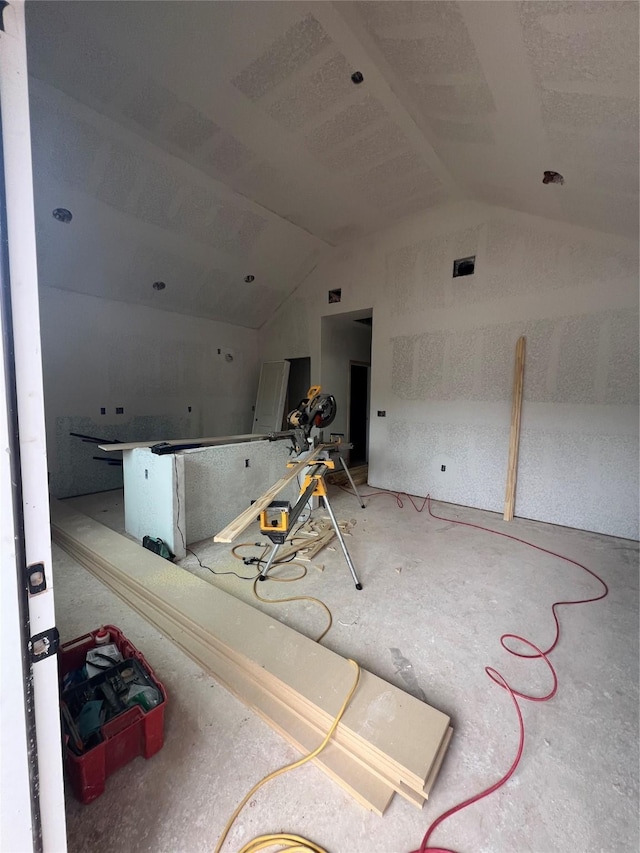 interior space featuring vaulted ceiling and visible vents