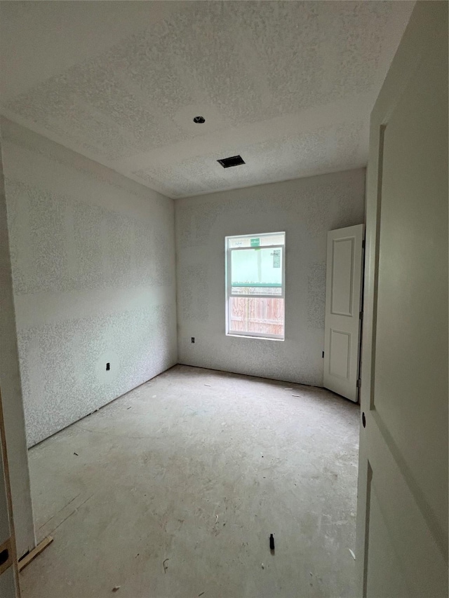 empty room featuring a textured ceiling