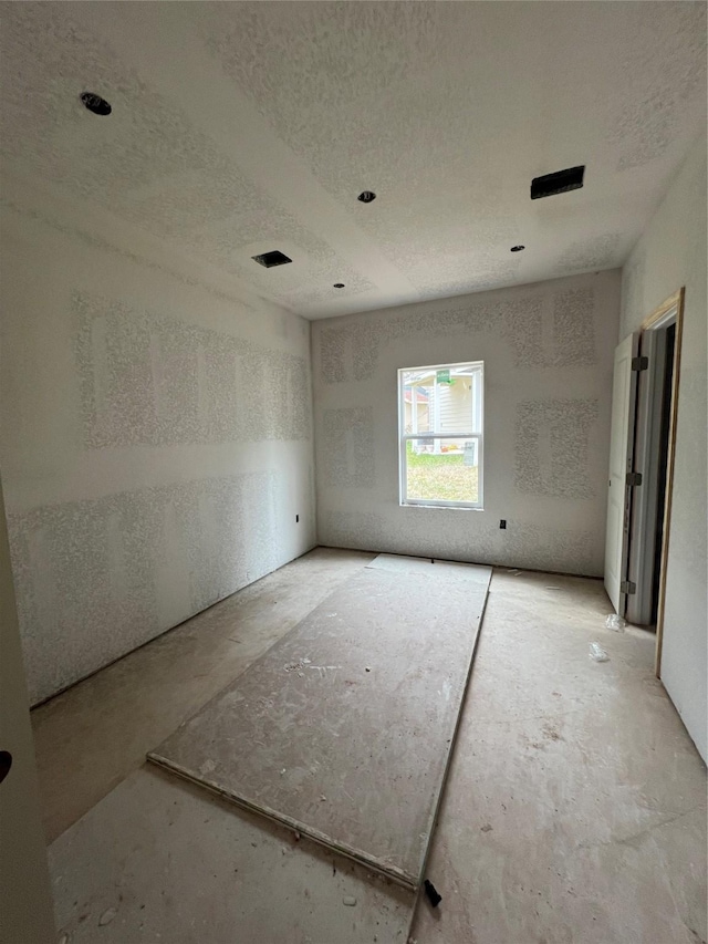 empty room with a textured ceiling