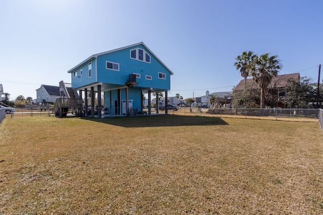 rear view of house featuring a yard