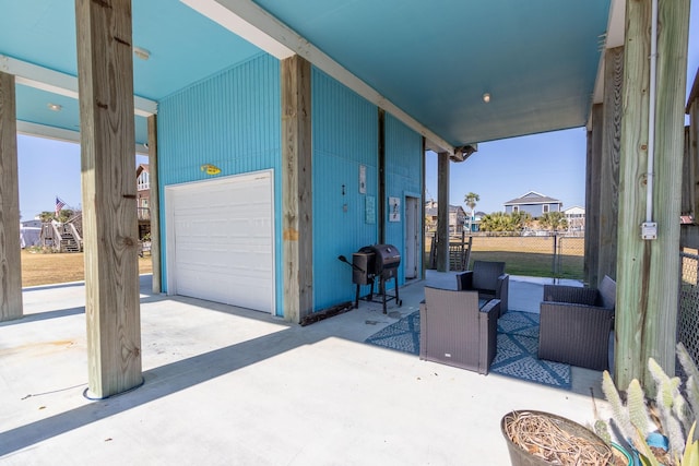 view of patio featuring a grill and a garage