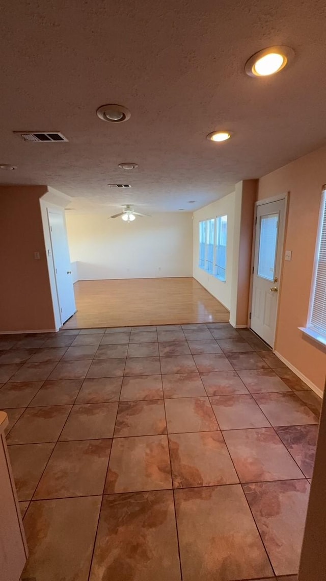 hall featuring light tile patterned floors