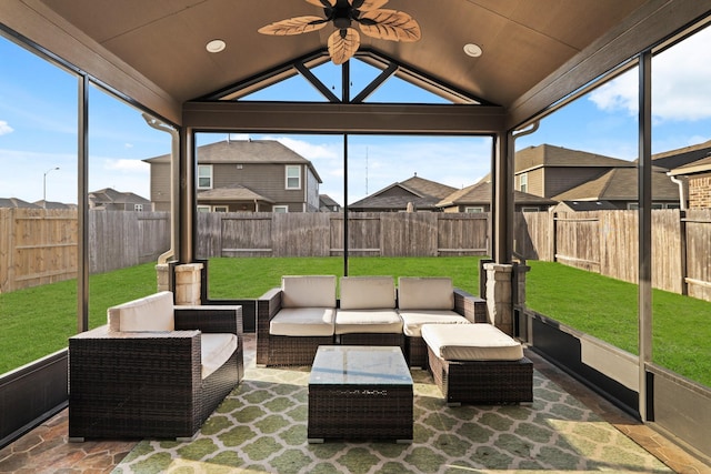 sunroom / solarium featuring ceiling fan, plenty of natural light, and vaulted ceiling