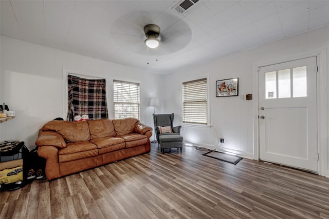 living room with hardwood / wood-style floors and ceiling fan