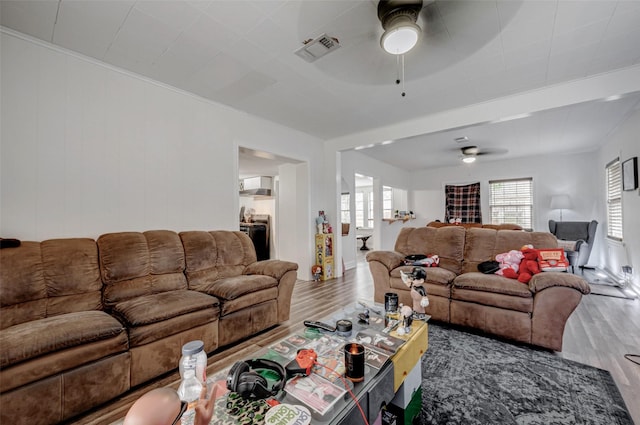 living room with plenty of natural light, hardwood / wood-style floors, and ceiling fan