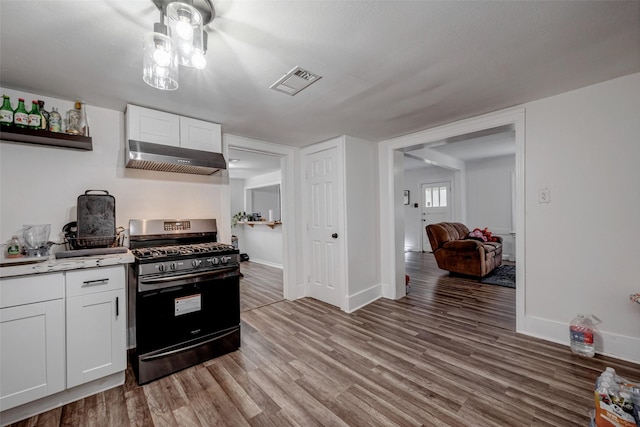 kitchen with white cabinetry, stainless steel range with gas cooktop, wall chimney exhaust hood, and wood-type flooring