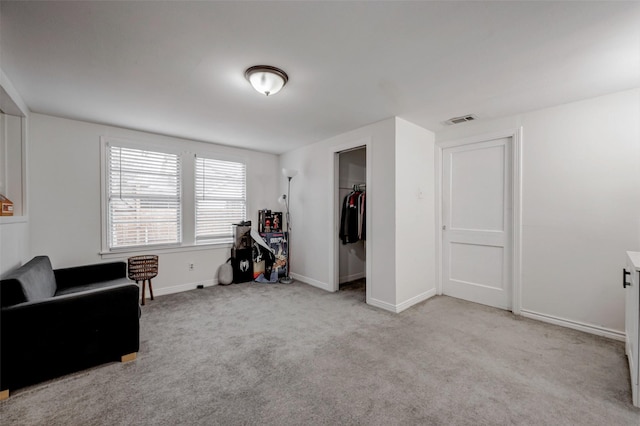 sitting room featuring light colored carpet