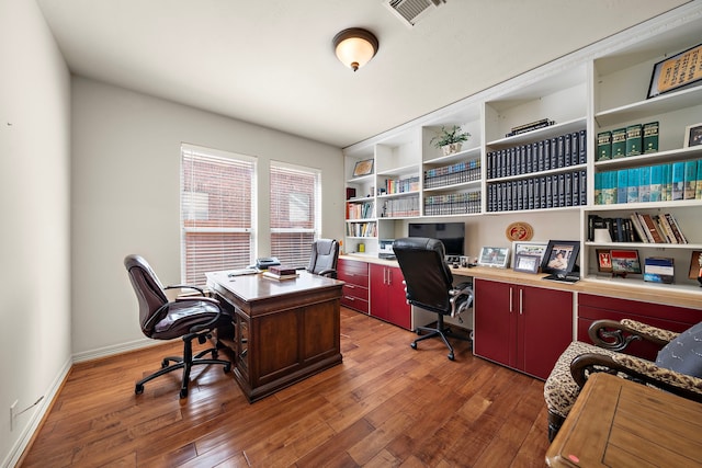 home office with dark wood-type flooring