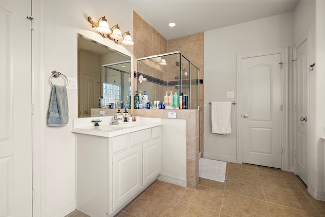 bathroom featuring vanity, tile patterned floors, and walk in shower