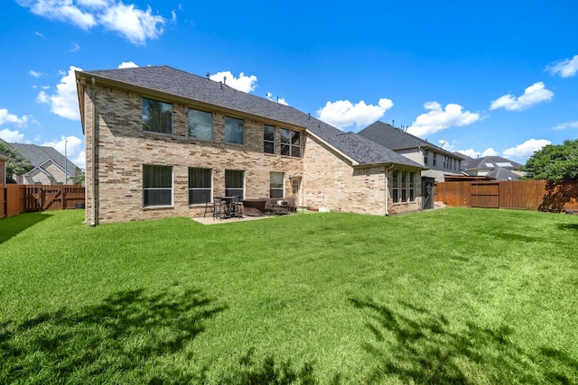 back of property featuring a patio area and a lawn