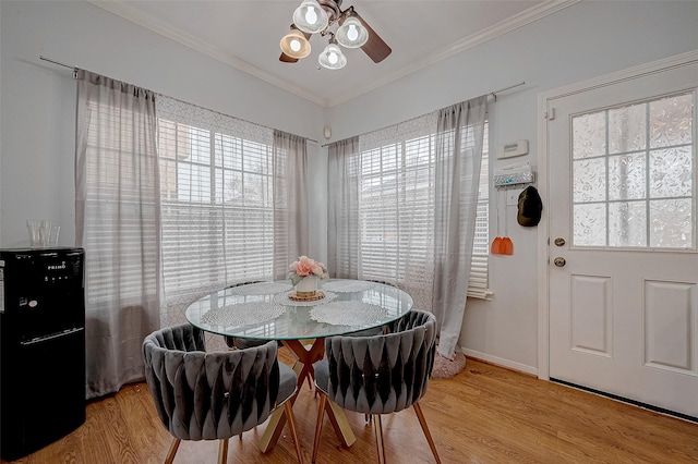 dining room featuring crown molding, ceiling fan, and light hardwood / wood-style flooring