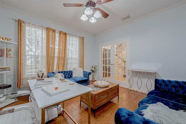 office space with french doors, ceiling fan, ornamental molding, and light hardwood / wood-style flooring