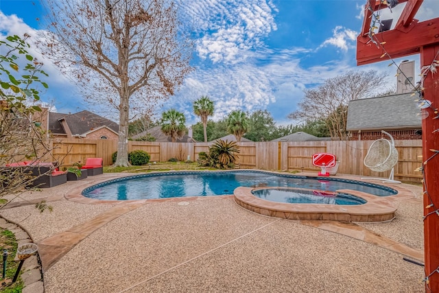 view of swimming pool with an in ground hot tub and a patio area