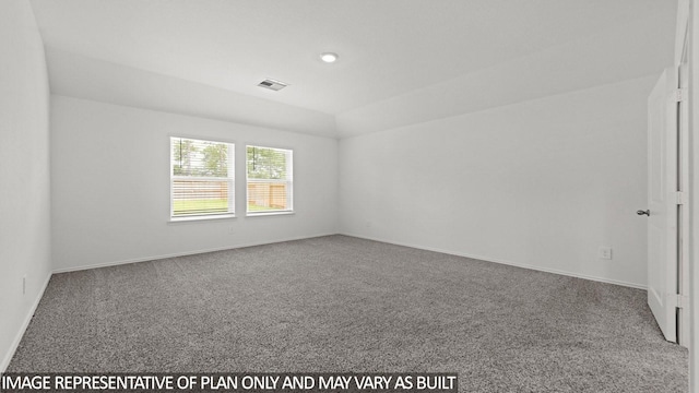 carpeted spare room with vaulted ceiling