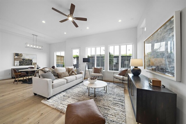 living room with plenty of natural light, ceiling fan, and light hardwood / wood-style flooring