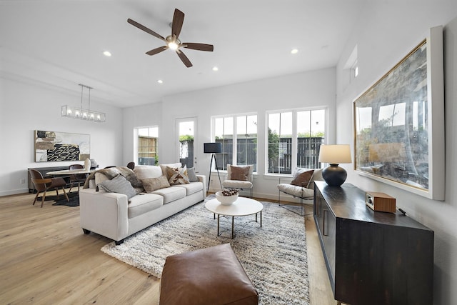 living area with recessed lighting, baseboards, plenty of natural light, and light wood finished floors