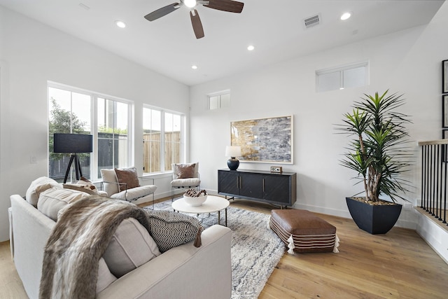 living area with visible vents, recessed lighting, baseboards, and wood finished floors