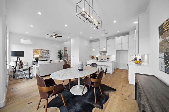 dining area with recessed lighting, light wood-style flooring, and a ceiling fan