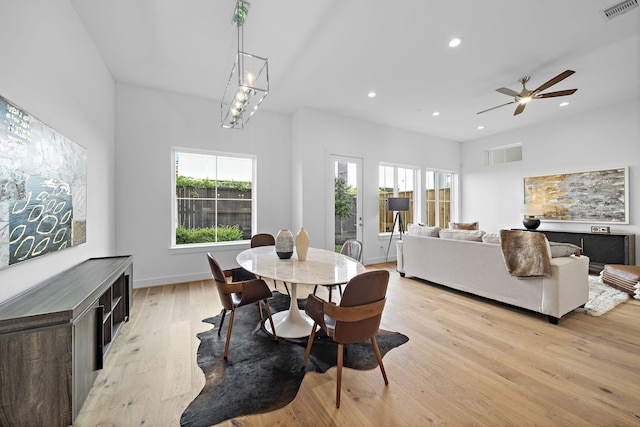 dining space featuring light wood finished floors, visible vents, recessed lighting, and baseboards