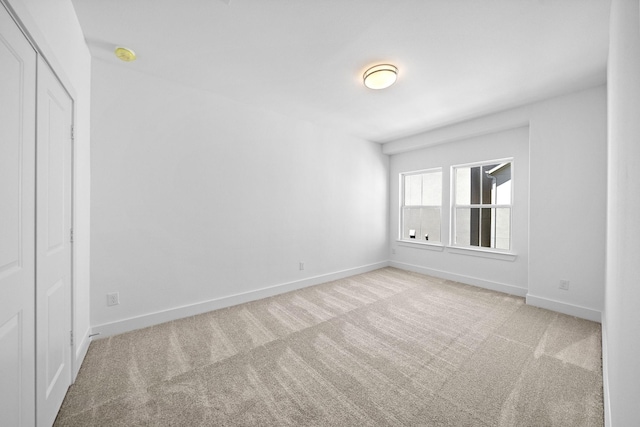 carpeted spare room with baseboards