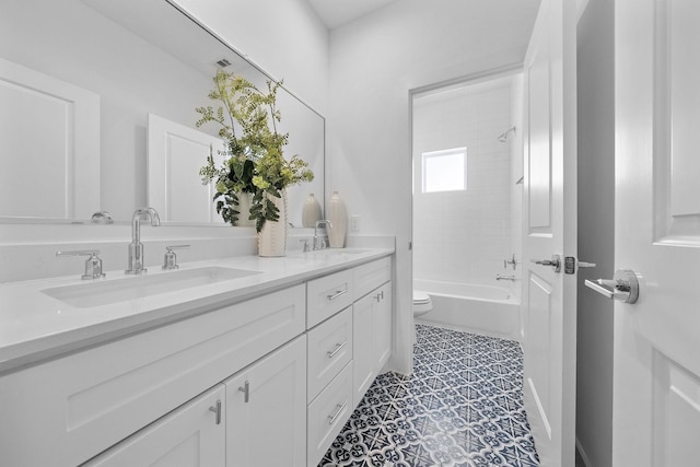 full bathroom featuring double vanity, toilet,  shower combination, and a sink