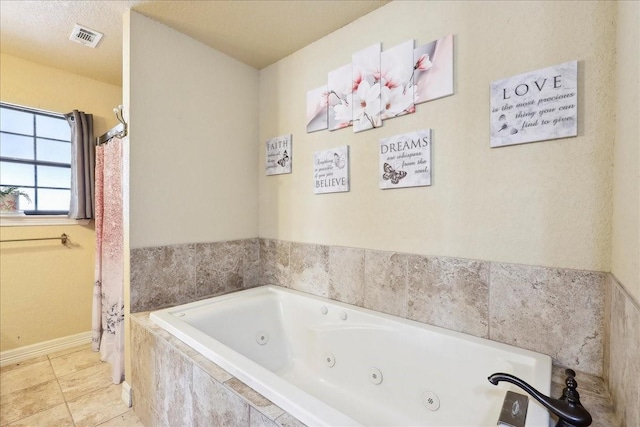 bathroom featuring tiled bath and tile patterned floors