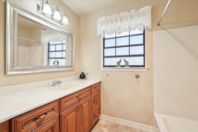 bathroom with plenty of natural light, bathing tub / shower combination, tile patterned flooring, and vanity