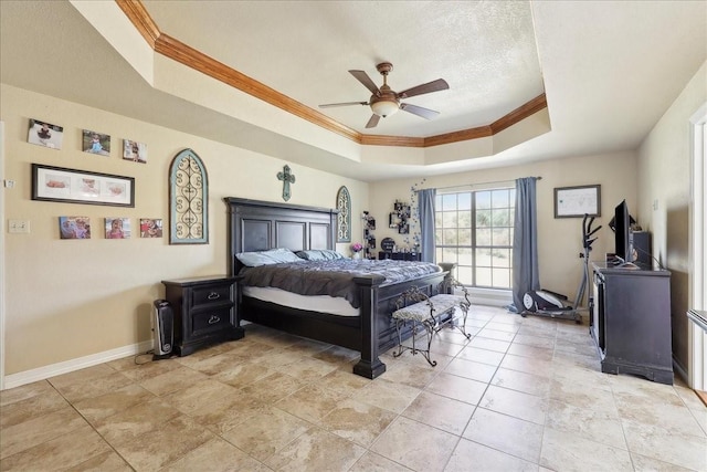 tiled bedroom featuring ceiling fan, a tray ceiling, ornamental molding, and a textured ceiling