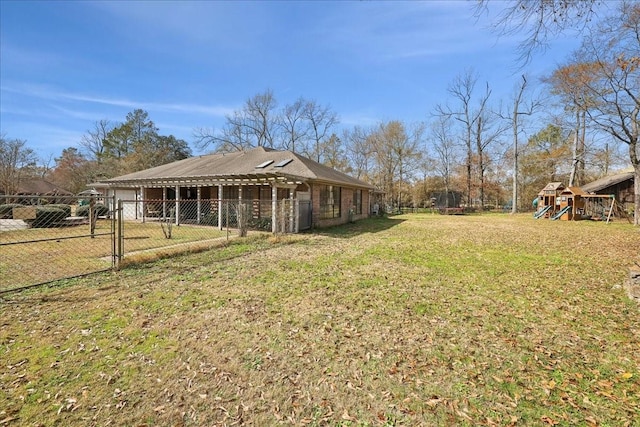 view of yard featuring a playground and an outbuilding