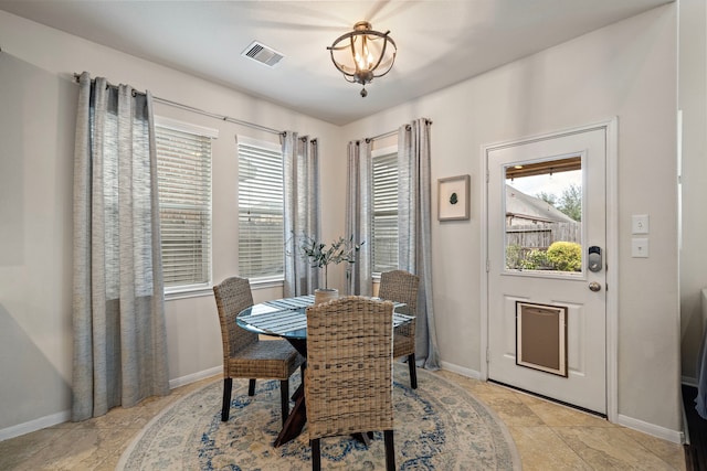 dining room with plenty of natural light and a notable chandelier