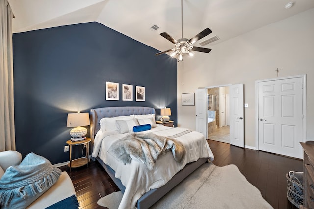 bedroom with ceiling fan, dark hardwood / wood-style floors, connected bathroom, and high vaulted ceiling